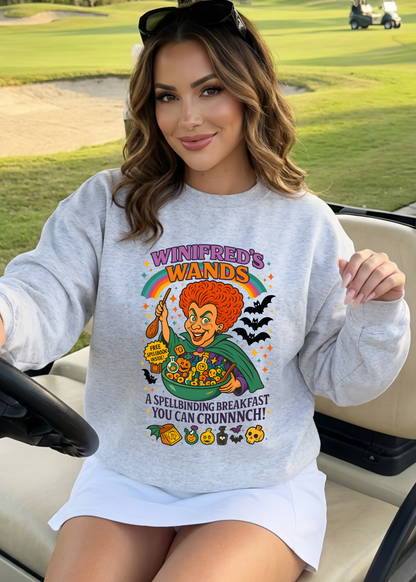 Woman wearing a sweatshirt with a Halloween-themed graphic in a golf cart on a golf course.