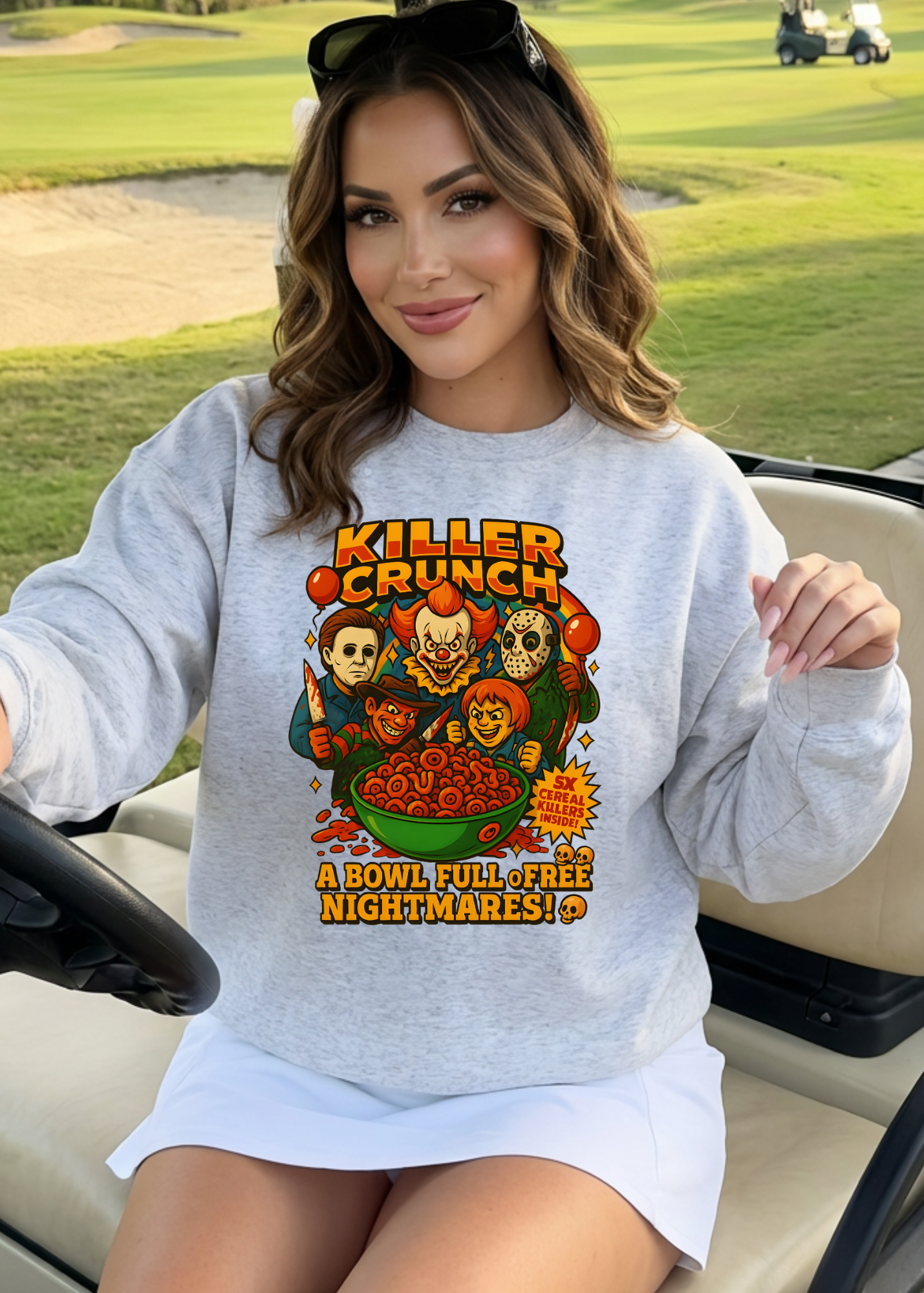 Woman wearing a sweatshirt with a graphic design of Killer Crunch cereal on a golf course.