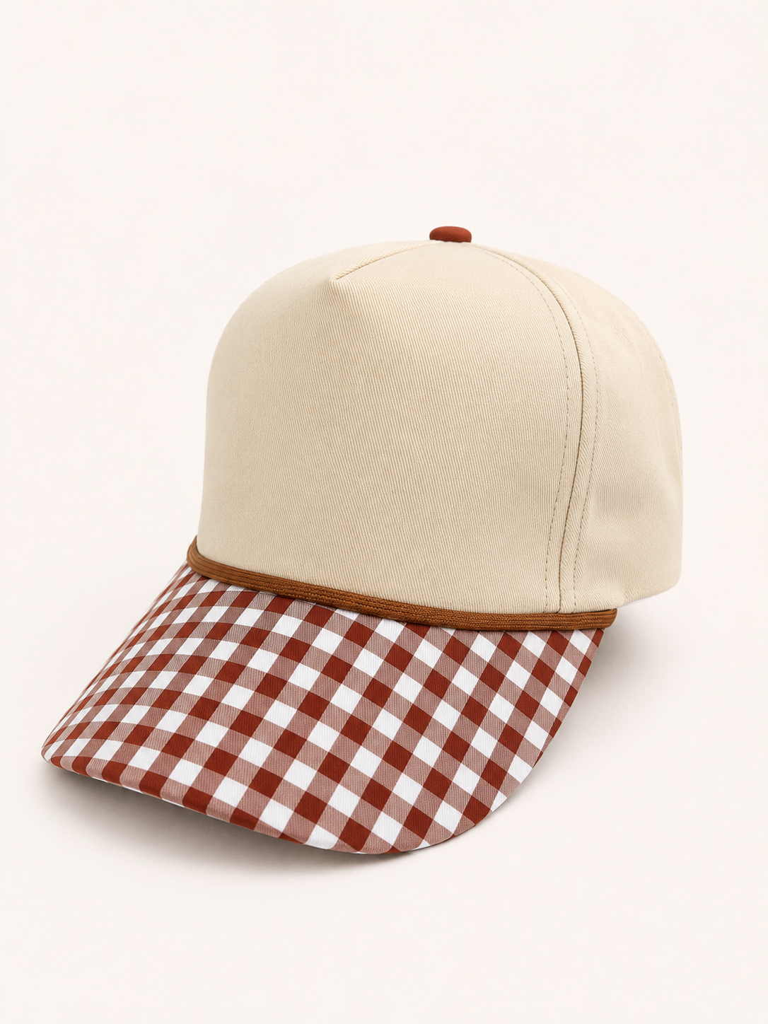 Beige cap with a brown and white checkered visor on a white background