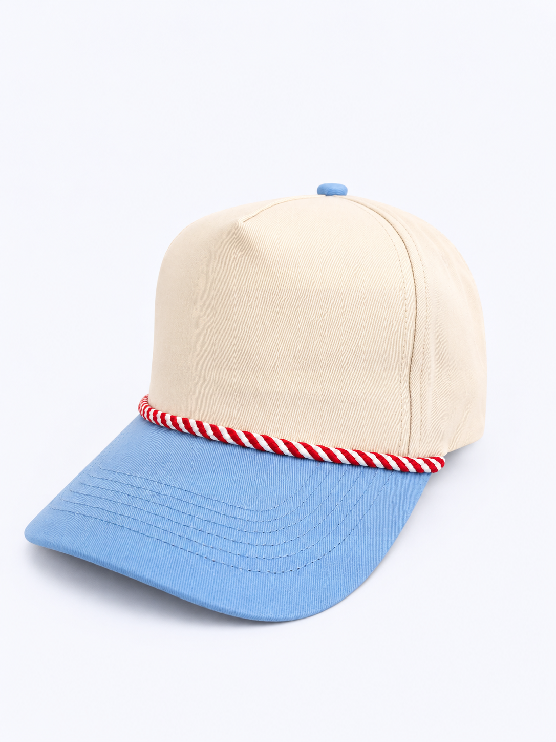 Beige and blue cap with a red and white striped band on a light gray background
