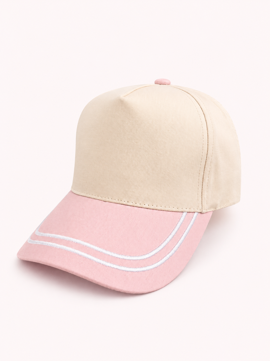 Two-tone pink and beige cap on a white background
