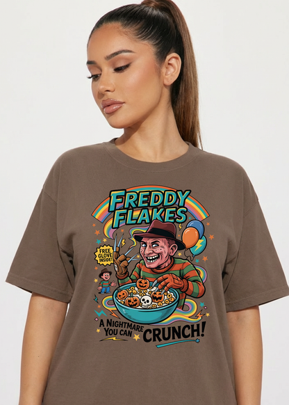 Person wearing a brown t-shirt with 'Freddy Flakes' graphic design.