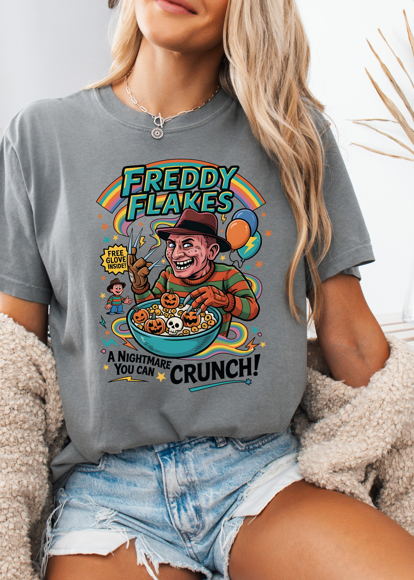 Person wearing a gray t-shirt with a colorful graphic design featuring a character and text.