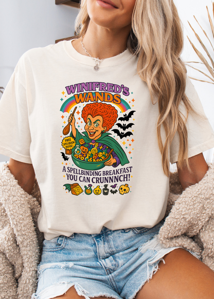 Person wearing a white t-shirt with a colorful graphic design featuring a character and text.