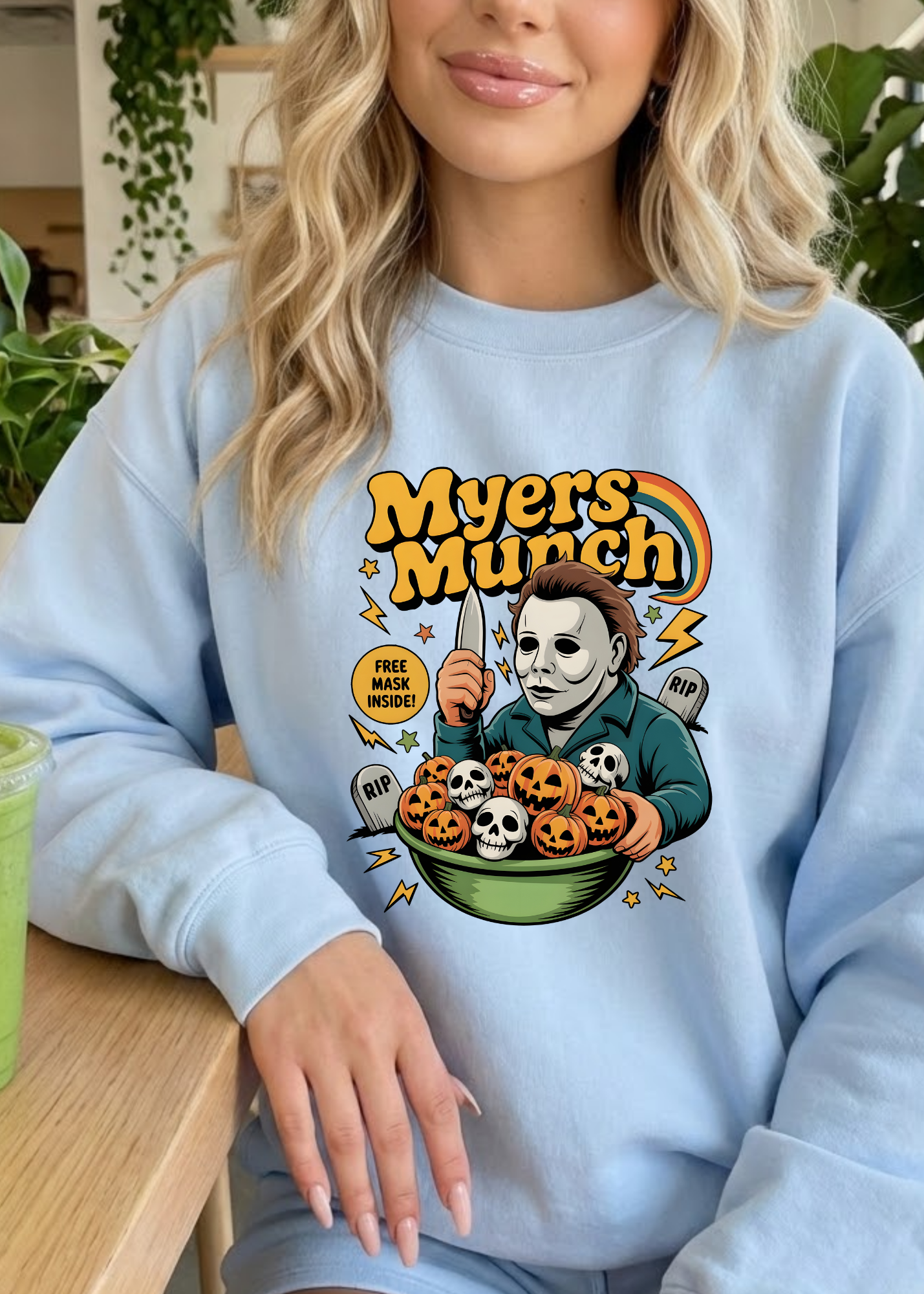 Person wearing a light blue sweatshirt with 'Myers Munch' graphic design.