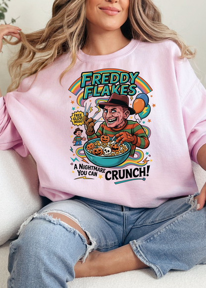 Person wearing a pink sweatshirt with a colorful graphic design of Freddy Flakes, a cartoon character, and text.