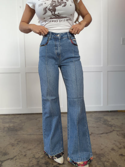 Woman wearing  in mediumwash shown in side view