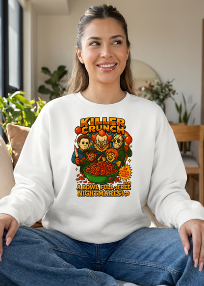 Woman wearing a white sweatshirt with a colorful graphic design sitting in a room with plants and furniture.