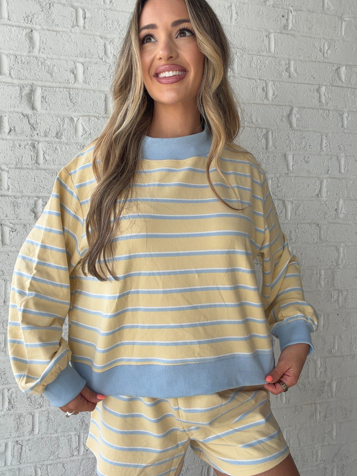 Front view of the yellow and baby blue striped mockneck lounge top