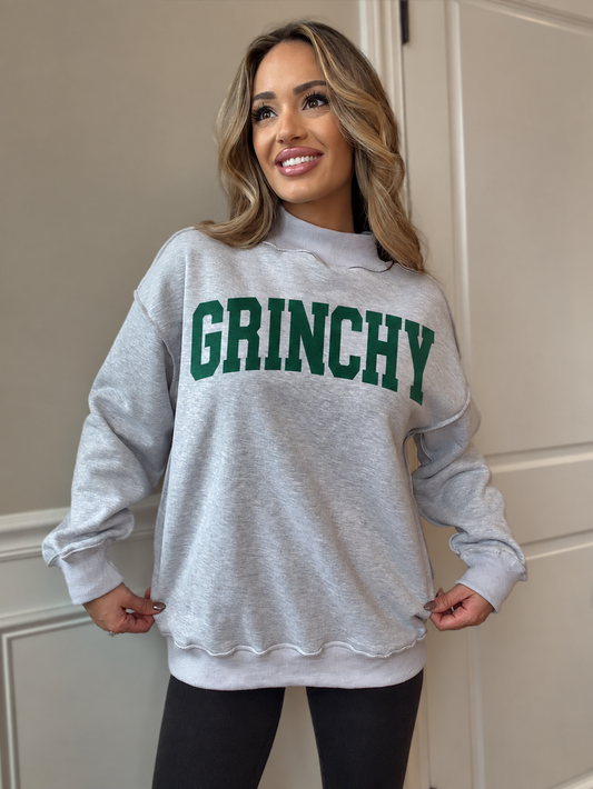 Chelsea wearing heather grey Tilly mockneck with dark green GRINCHY graphic